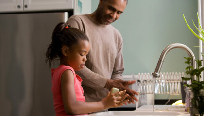 Father and His Child Washing Hands in The Kitchen | McLarty Wolf Litigation Lawyers