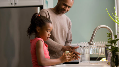 Father and His Child Washing Hands in The Kitchen | McLarty Wolf Litigation Lawyers